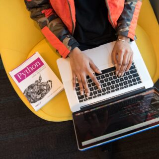 Woman Programming on a Notebook