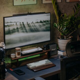 a flat screen tv sitting on top of a wooden desk