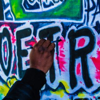 person doing wall graffiti