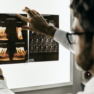 person in gray long sleeve shirt holding black tablet computer
