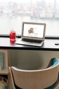 a laptop computer sitting on top of a wooden desk